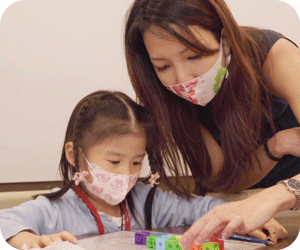 A teacher from The Learning Lab helping a student with problem solving during enrichment class