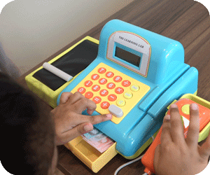 A kindergarten 2 (K2) student focusing on an assignment during tuition class at The Learning Lab